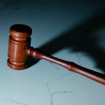 wooden gavel on a marble surface
